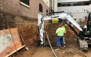 Construction workers using soil mixing pier to prepare the ground for underpinning in Sterling, VA